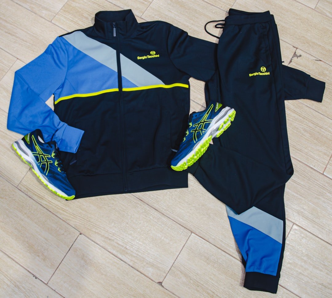 a-pair-of-tracksuits-and-a-pair-of-running-shoes-on-a-wooden-floor-ksuzzixk660